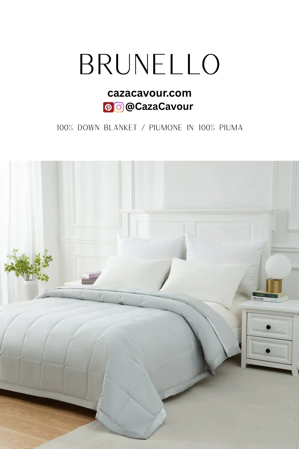 Luxurious light grey down blanket on a neatly made bed with white pillows in a bright bedroom