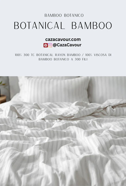 Striped botanical bamboo bed sheets and pillows in a bright, modern bedroom setting.