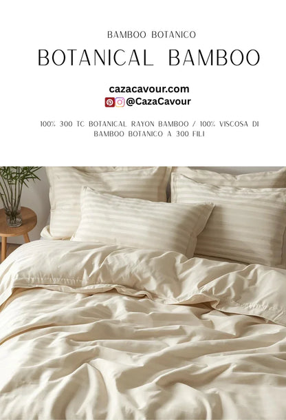 Cream bamboo botanical bedding set with striped pillows on a neatly made bed