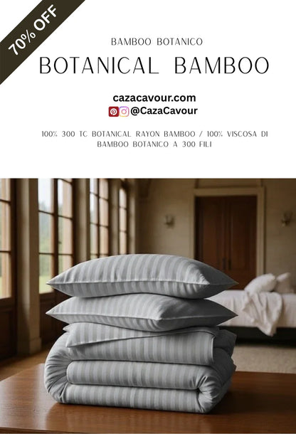 Stack of gray botanical bamboo bedding and pillows on table in sunlit bedroom, 70% off sale