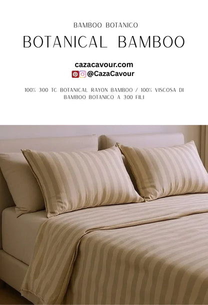 Neutral striped botanical bamboo rayon bedding set on a made bed with matching pillows