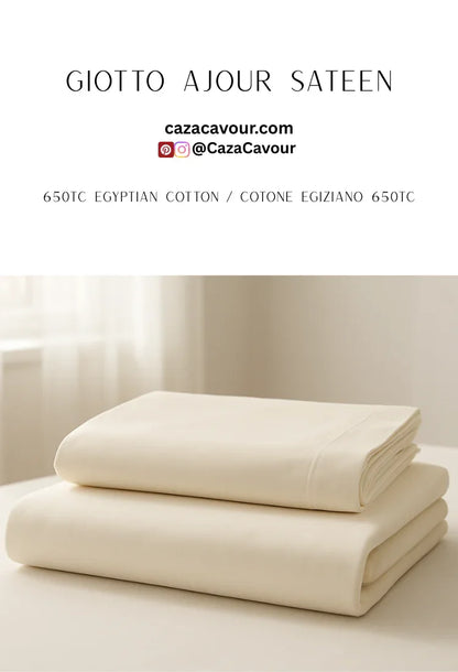 Ivory Egyptian cotton sateen sheets stacked on bed in sunlit room, 650 thread count