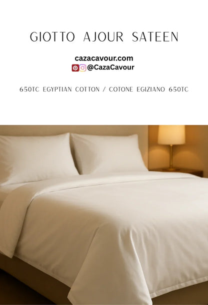 Ivory 650 thread count Egyptian cotton sateen bed linens on a modern bed with soft lighting