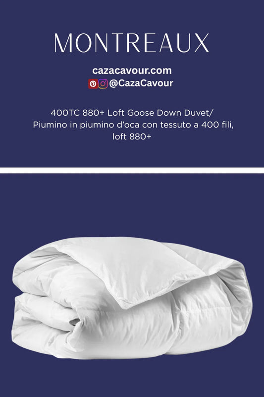 Folded white goose down duvet with 400 thread count cotton on blue background